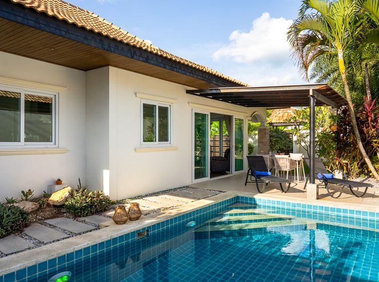 The private pool and sun loungers on a sunny day